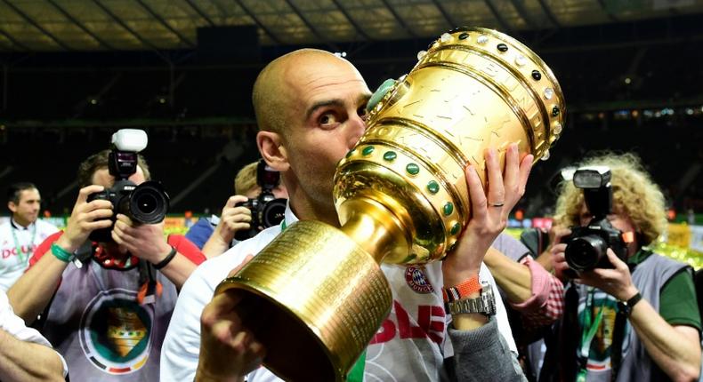 Pep Guardiola kisses the German Cup in May 2016, after Bayern Munich beat Borussia Dortmund in the final at Berlin's Olympic Stadium, just before he left to coach Manchester City