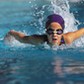 A young girl swimming in a pool