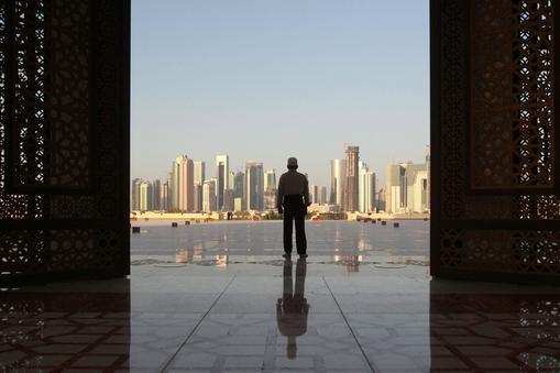 Man stands at Imam Muhammad ibn Abd al-Wahhab Mosque in Doha