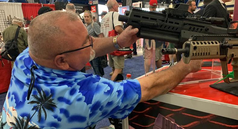 A man handles the IWI-12, a semi-automatic, gas-operated 12-gauge shotgun, inside of the National Rifle Association Annual Meeting at the George R. Brown Convention Center, on May 27, 2022, in Houston, Texas.