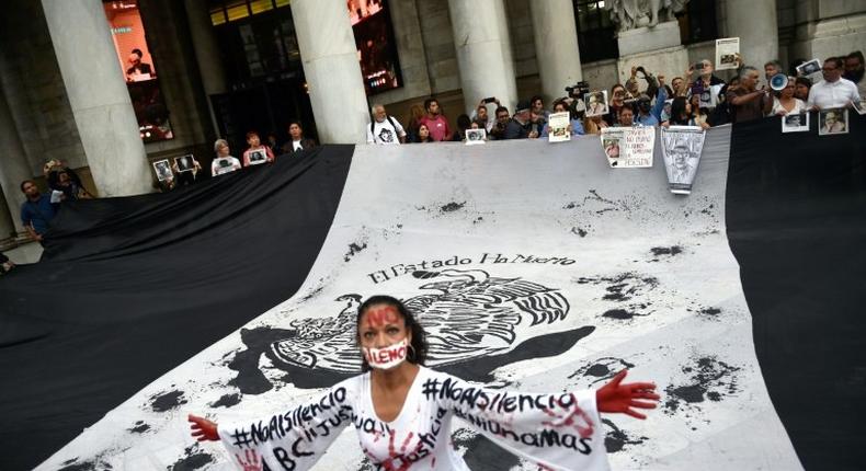 Journalists take part in a protest to mark one month since the murder of their colleague Javier Valdez, a noted expert on the country's drug cartels and AFP contributor, in Mexico City, on June 15, 2017