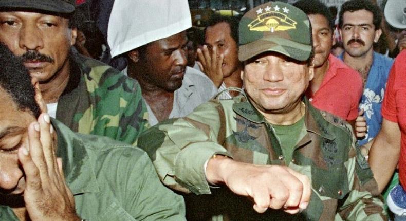 Panamanian dictator Manuel Noriega playfully fakes a punch to a supporter at the height of his power in 1989