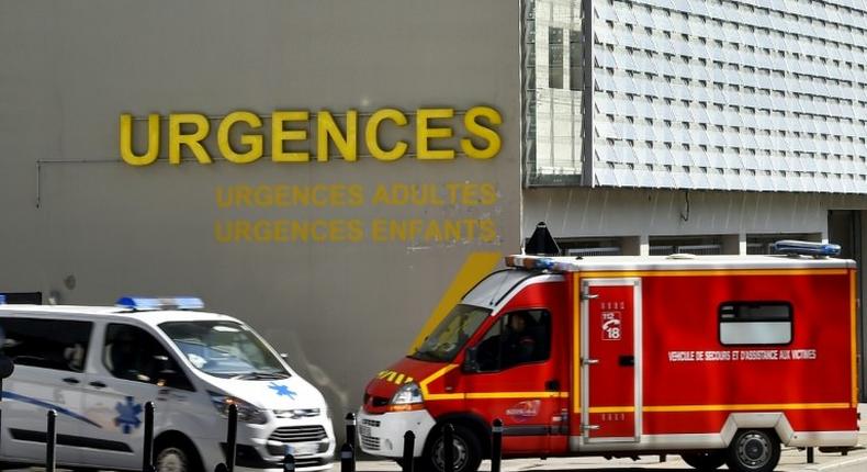 An ambulance and a firefighting vehicle are pictured in front of the Nantes CHU Hospital in this file photo from March 2017