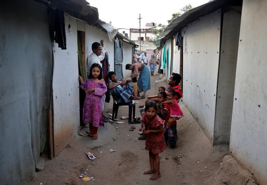 FILE PHOTO: People belonging to Rohingya Muslim community sit outside their makeshift houses on the outskirts of Jammu