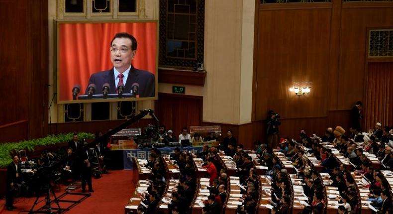 Chinese Premier Li Keqiang announces a trimmed 2017 GDP growth target of around 6.5 percent