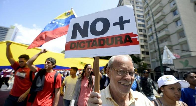 Venezuelan opposition activists shout slogans during a protest against the government of President Nicolas Maduro on April 6, 2017 in Caracas