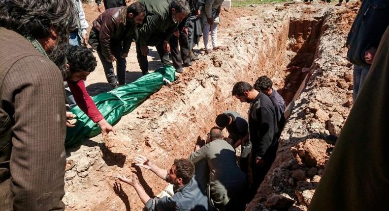 Syrians dig a grave to bury the bodies of victims of a a suspected chemical attack in Khan Sheikhun, a rebel-held town in Syria’s northwestern Idlib