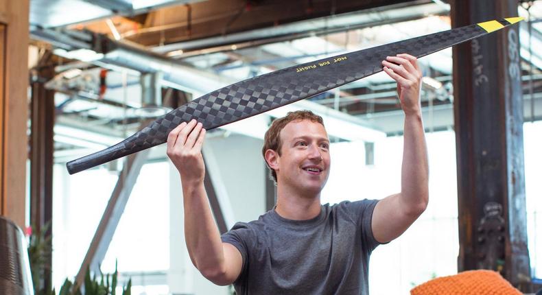 CEO Mark Zuckerberg holding a model wing for Facebook's internet-beaming mark Zuckerberg Aquila drone.