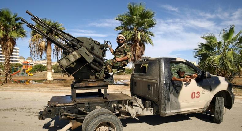 Forces loyal to Libyan strongman Khalifa Haftar man pickup trucks in Benghazi on October 24, 2018