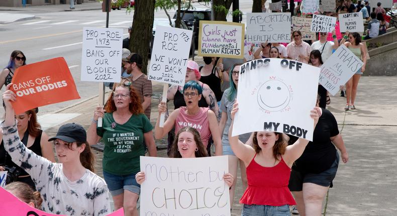 Protesters in Dayton, Ohio, hold placards expressing their opinion at a pro abortion rights rally.