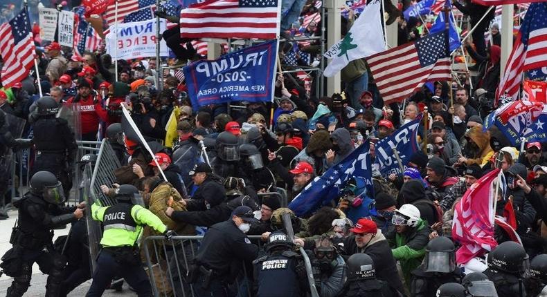 Trump supporters clash with police and security forces as they push barricades to storm the US Capitol in Washington D.C on January 6, 2021.
