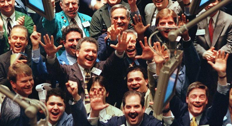 Traders cheer on the floor of the New York Stock Exchange.STAN HONDA/AFP via Getty Images)