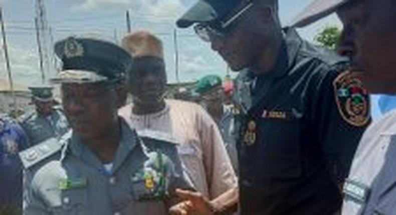 The Controller, Seme Area Command of Nigeria Customs Service, Comptroller Dera Nandi, handing over 553 parcels of cannabis sativa seized by his men to Mr Abubakar Wada, the Commander, National Drugs Law Enforcement Agency (NDLEA) on Wednesday in Semé.