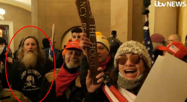 Robert Packer is seen wearing a Camp Auschwitz sweatshirt inside the US Capitol Building on January 6, 2021. He was arrested on January 13, and the DOJ included this image in his court documents.