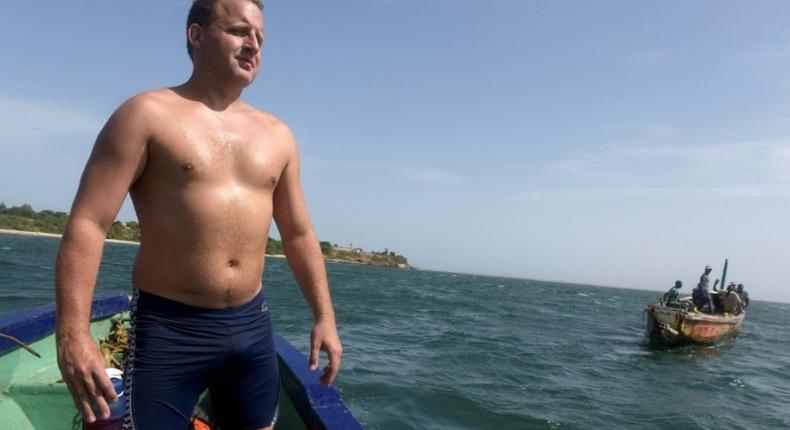 British swimmer Ben Hooper stands on a boat during a training session in Dakar on October 28, 2016