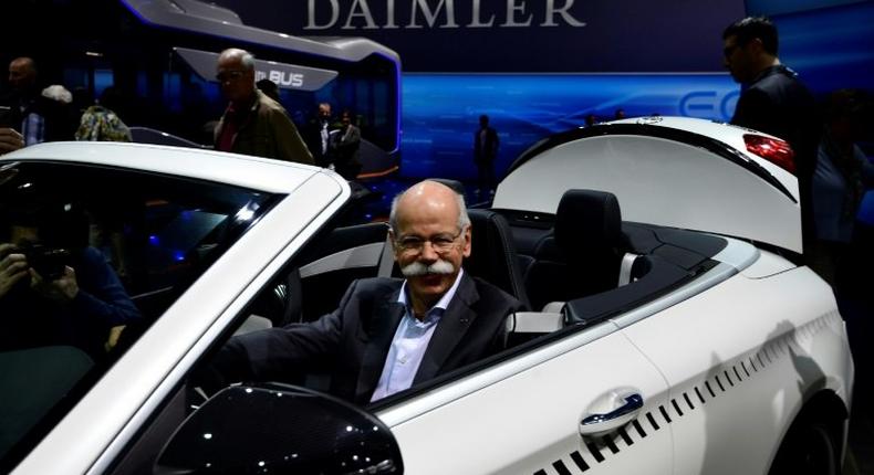 CEO of German carmaker Daimler and Mercedes-Benz, Dieter Zetsche, poses inside a Mercedes-AMG C 63 Cabriolet ahead of the annual shareholders meeting in Berlin, on March 29, 2017