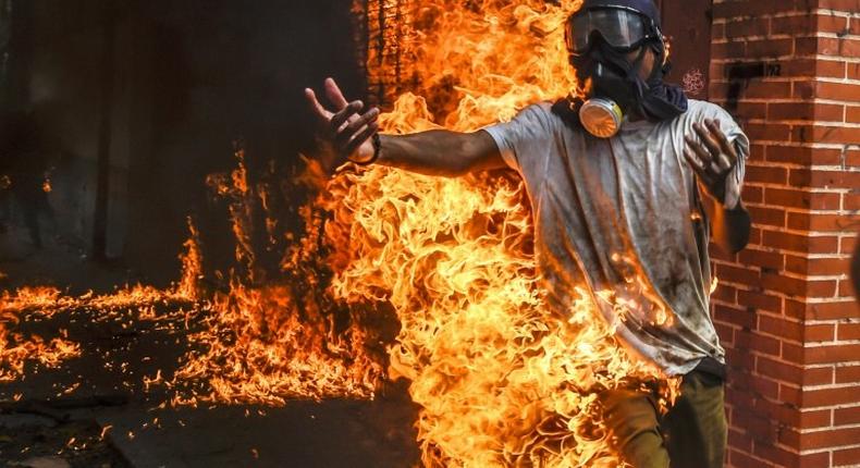 A demonstrator catches fire during clashes in a Caracas protest