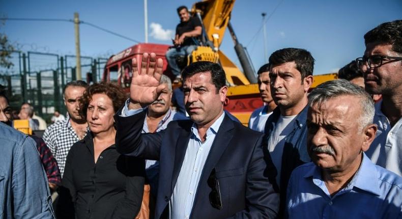Pro-Kurdish Peoples' Democratic Party leader Selahattin Demirtas waves during a peace rally against the war in Syria on September 4, 2016 in Istanbul