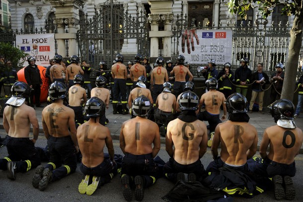 Firefighters take part in a protest in front of the regional parliament of Asturias demanding better