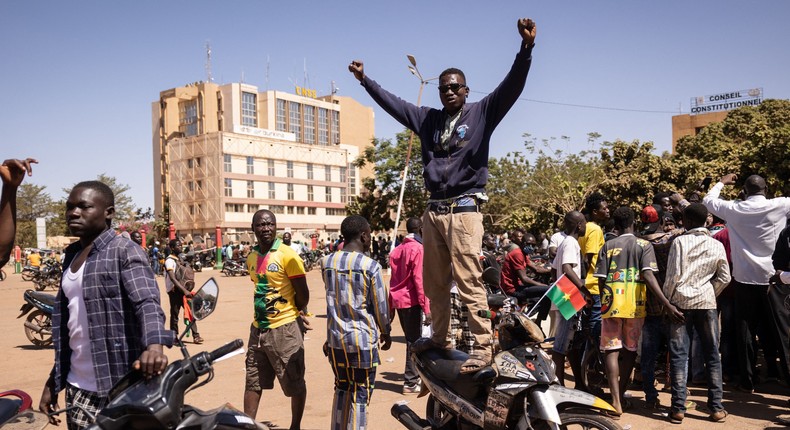 A man standing on his motorcycle gestures as people gather at Nation square to support military in Ouagadougou on January 24, 2022.