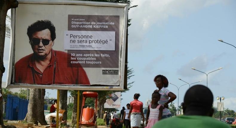 French-Canadian journalist Guy-Andre Kieffer pictured on the billboard was last seen in a car park in Abidjan in April 2004 with Michel Legre