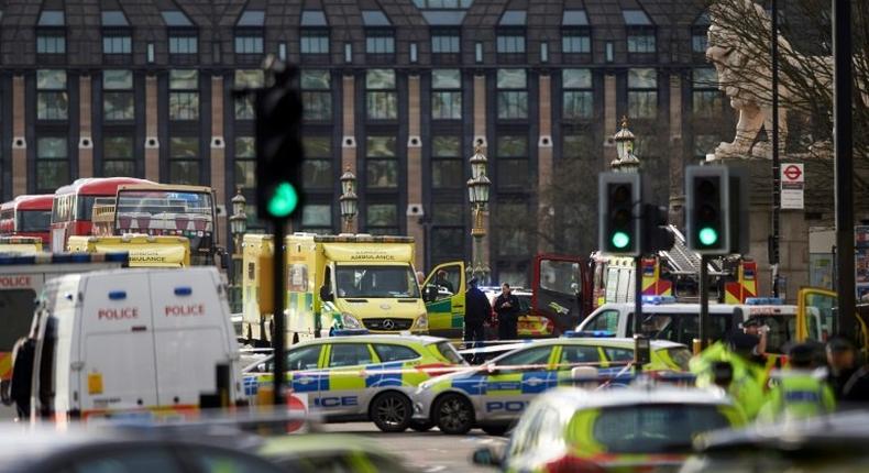 Members of the emergency services work on Westminster Bridge, alongside the Houses of Parliament in central London on March 22, 2017 during an emergency incident