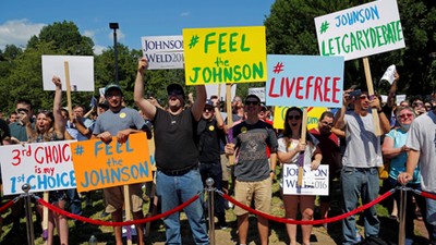 Supporters cheer at a campaign rally with Libertarian presidential candidate Johnson and vice presid