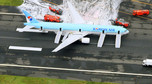 An aerial picture shows passengers standing near a Korean Air Lines plane after smoke rose from one of its engines at Haneda airport in Tokyo