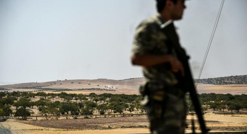 A Turkish soldier stands guard in the Turkish Syrian border city of Karkamis