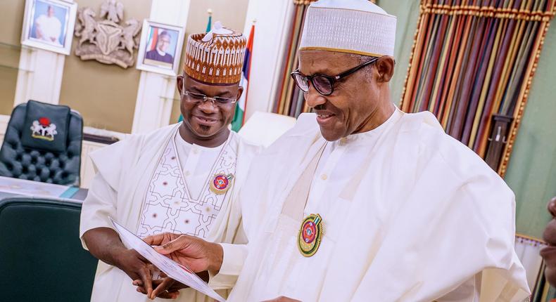 Governor of Kogi, Yahaya Bello (L) presents his Certificate of Return to President Muhammadu Buhari in 2019 [Twitter/@BashirAhmaad]