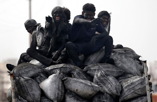 Coal workers travel on the back of their lorry in Barsana