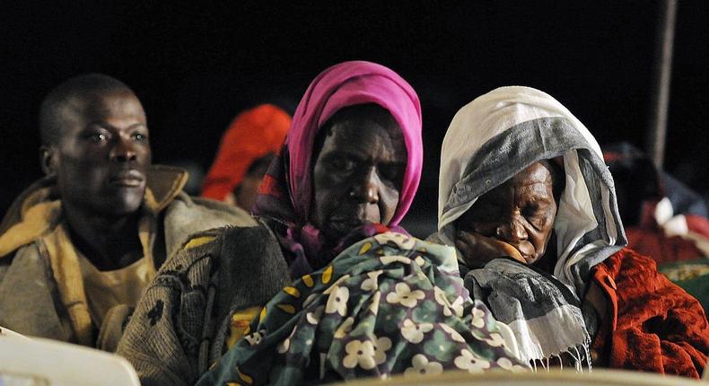 Villagers of Kogelo doze off as they wait for the results of the American Presidential polls projected on November 5, 2008 at an open field via satellite, where they bore rain and cold hoping to hear that 'their son', Barack Obama, is now elected. (Photo by TONY KARUMBA/AFP via Getty Images)