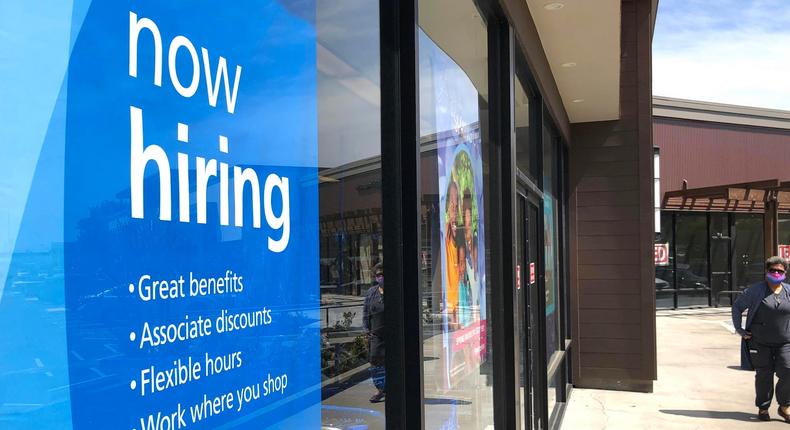 A pedestrian walking by a now-hiring sign at Ross Dress For Less store on April 2 in San Rafael, California.
