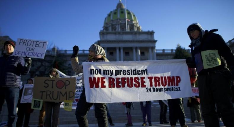 Protestors demonstrate outside the Pennsylvania Capitol Building in Harrisburg on December 19, 2016