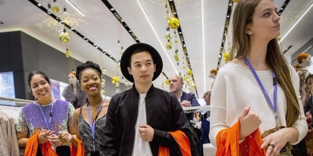 Employees wait to greet shoppers during British clothing retailer Topshop's grand opening of the chain's New York flagship store