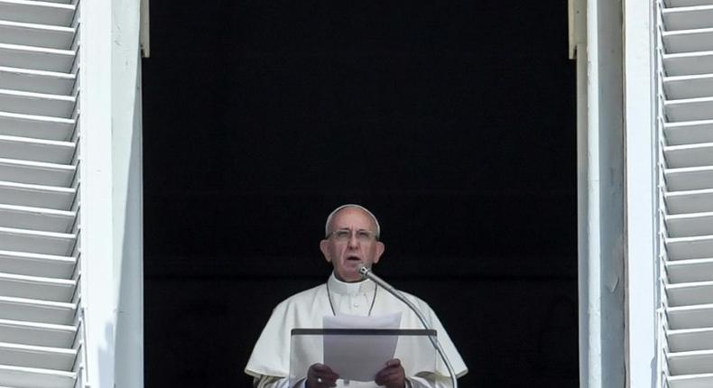 Pope Francis delivers his speech to the crowd from the window of the apostolic palace overlooking St Peter's square during the Sunday Angelus prayer, on July 2, 2017 at the Vatican