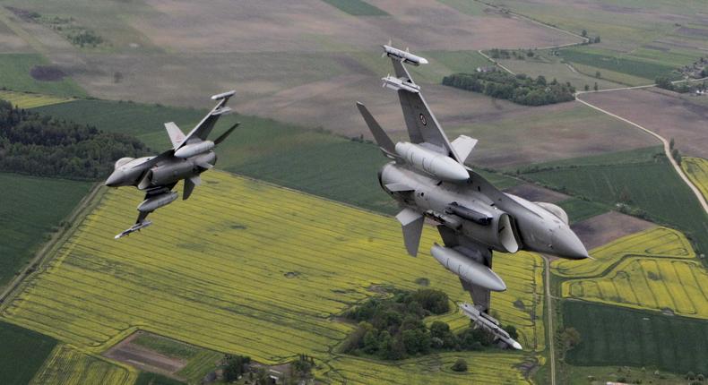 A Norwegian F-16, right, and an Italian Eurofighter Typhoon over the Baltics during a NATO air-policing mission from Zokniai air base near Siauliai, Lithuania, on May 20, 2015.