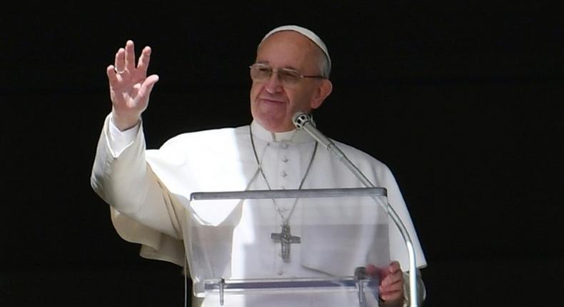 Pope Francis waves to the crowd from the window of the apostolic palace during the Sunday Angelus prayer, on March 5, 2017 at St Peter's square in Vatican