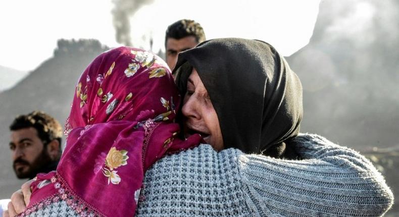 Families of trapped miners console each other at the accident site at a copper mine in Siirt, southeast Turkey on November 18, 2016