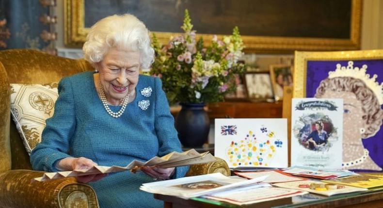 Britain's Queen Elizabeth II looks at a display of memorabilia . Photo credit: AP-Yonhap.