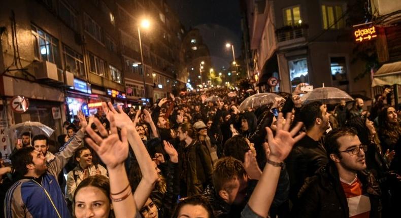 Supporters of the No gesture and shout in Istanbul to protest alleged poll violations