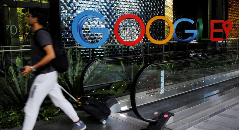FILE PHOTO: A man passes a Google signage outside their office in Singapore May 24, 2019. REUTERS/Edgar Su/File Photo