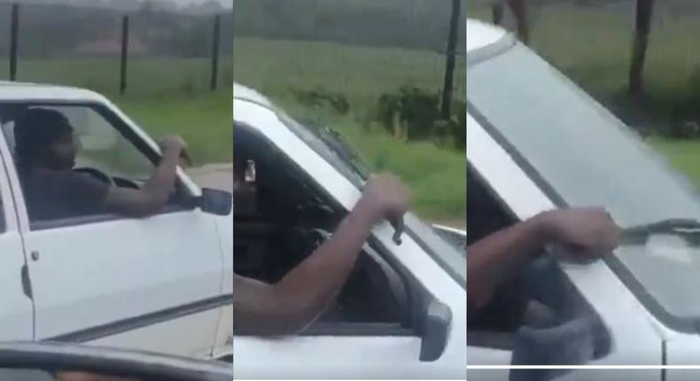 Rickety car driver uses his hand as manual wiper in heavy rain (Video)