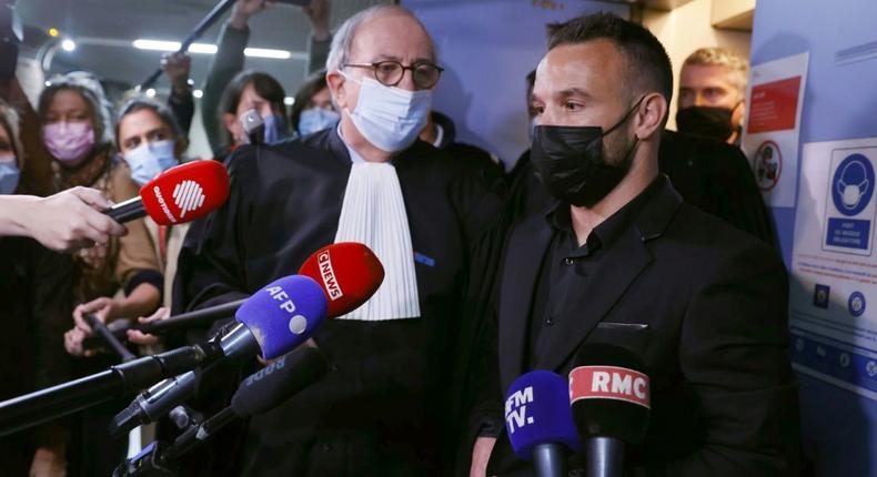 French football player Mathieu Valbuena (R), involved in a 'sex tape case', addresses media representatives next to lawyer Paul Albert Iweins (C) inside a court Creator: Thomas SAMSON