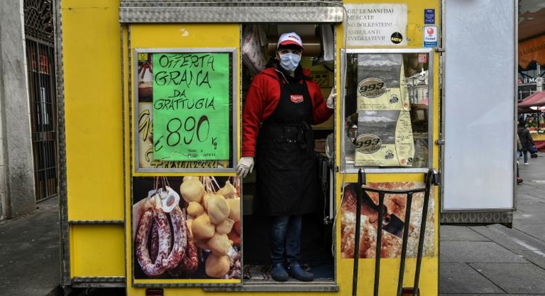 Italians rely on delicacy stores like Gina's at the Porta Palazzo food market in Turin for comfort through the coronavirus emergency