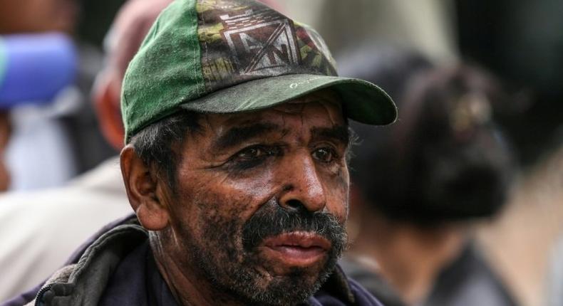 A miner waits for news during search operations at the illegal coal mine in the town of Cucunuba, central Colombia