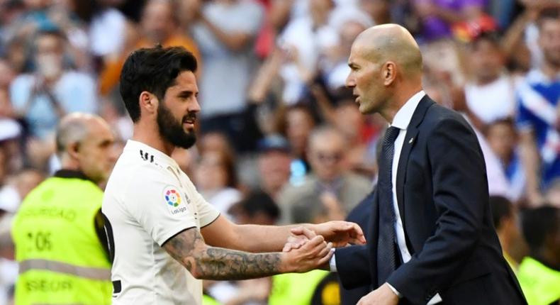 Real Madrid's Spanish midfielder Isco (L) celebrates scoring the opening goal with Real Madrid's French coach Zinedine Zidane during the Spanish league football match between Real Madrid CF and RC Celta de Vigo at the Santiago Bernabeu stadium in Madrid on March 16, 2019.