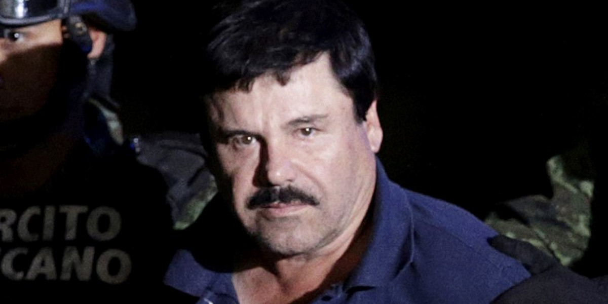 Recaptured drug lord Joaquin "El Chapo" Guzman is escorted by soldiers at the hangar belonging to the Mexican attorney general in Mexico City, January 2016.
