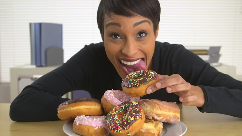 Woman eating doughnut(shutterstock) 