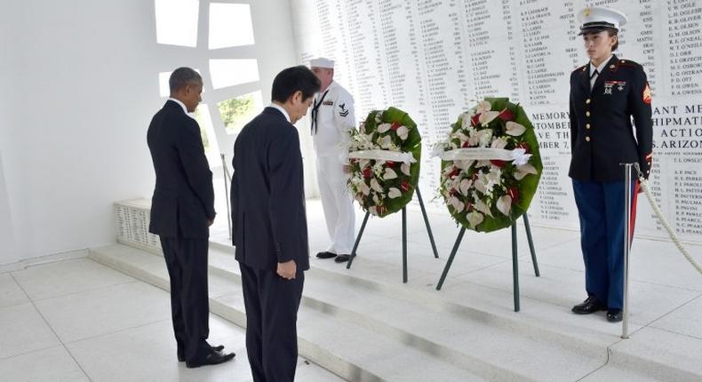 US President Barack Obama (L) and Japanese Prime Minister Shinzo Abe place wreaths at the USS Arizona Memorial at Pearl Harbor in Honolulu, Hawaii on December 27, 2016